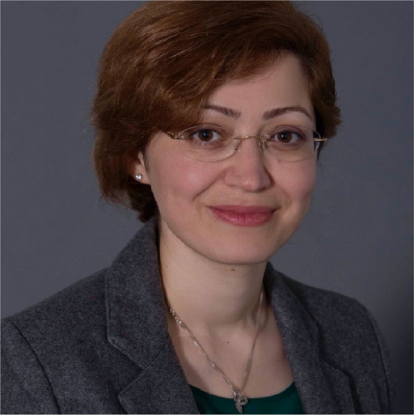 Parisa Kordjamshidi, a woman with short brown hair, glasses, wearing a suit and necklace